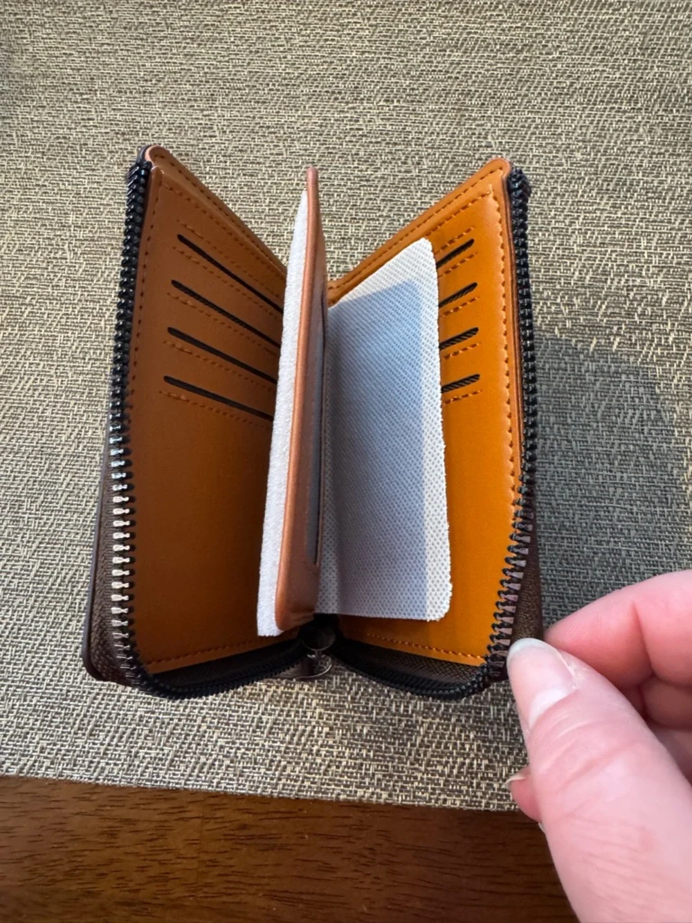 Men’s zip leather wallet in brown.‎